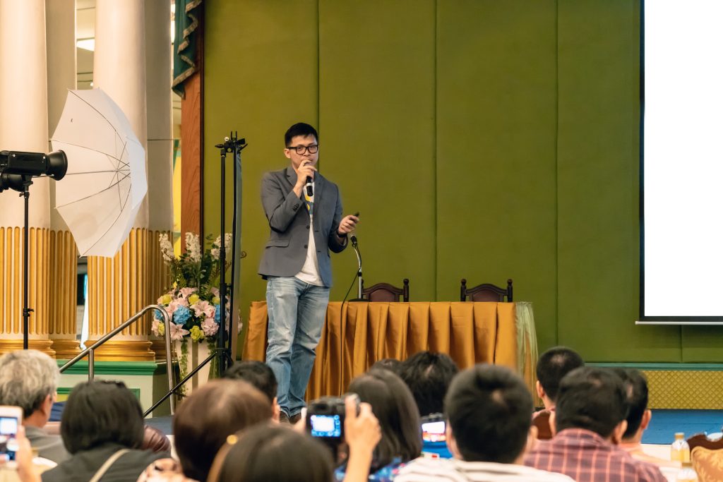 Asian speaker teaching Leadership development on stage