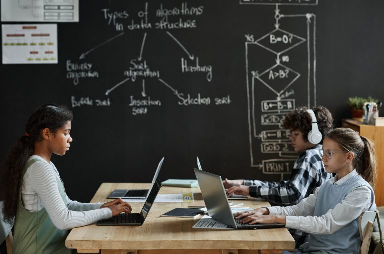 low income children learning to work with computer program at college preparatory course